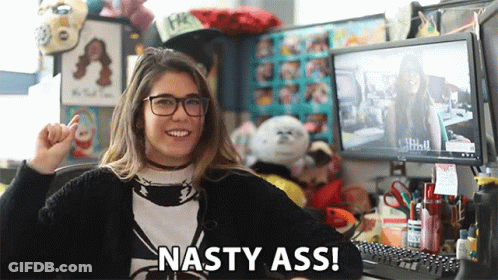A Woman Sitting In Front Of A Computer With The Words Nasty Ass Written On The Bottom GIF