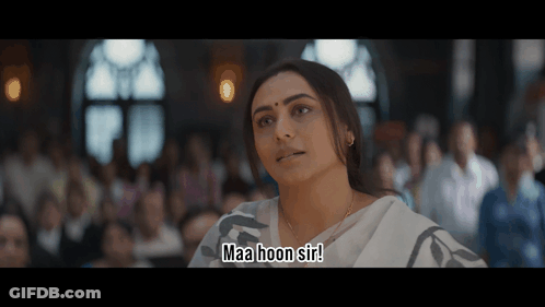 A Woman Sitting In Front Of A Crowd Says Maa Hoon Sir GIF