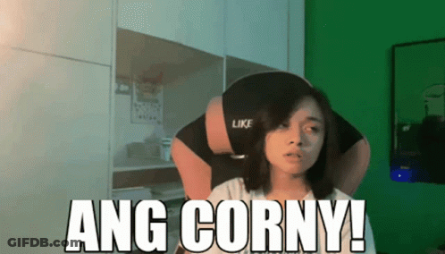 A Woman Sitting In Front Of A Green Wall With The Words Ang Corny On It GIF