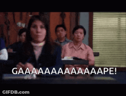 A Woman Sitting In Front Of A Group Of People With The Words Gaaaa Written On The Bottom GIF