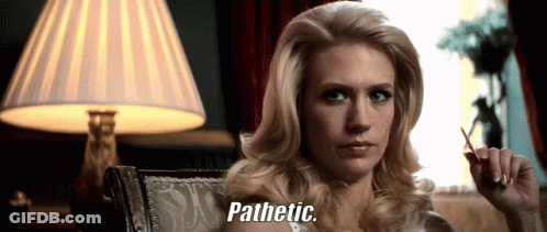 A Woman Sitting In Front Of A Lamp With The Words Pathetic Written On Her Face GIF