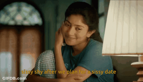 A Woman Sitting In Front Of A Lamp With The Words Sissy Shy After We Plan For A Sissy Date Below Her GIF