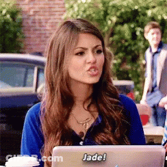 A Woman Sitting In Front Of A Laptop With A Sticker That Says Jade On It GIF