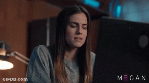 A Woman Sitting In Front Of A Laptop With The Name Megan On The Bottom Right GIF