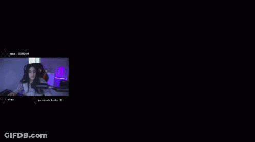 A Woman Sitting In Front Of A Microphone With A Number 8 In The Background GIF