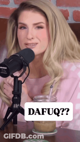 A Woman Sitting In Front Of A Microphone With A Sign That Says Dafuq On It GIF
