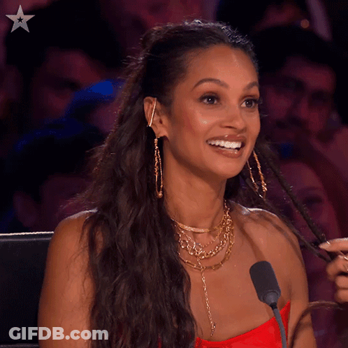A Woman Sitting In Front Of A Microphone With The Word Never Behind Her GIF