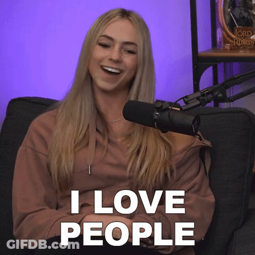A Woman Sitting In Front Of A Microphone With The Words " I Love People " Above Her GIF