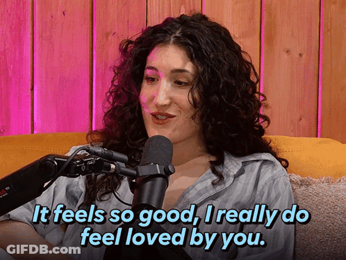 A Woman Sitting In Front Of A Microphone With The Words It Feels So Good I Really Do Feel Loved By You GIF