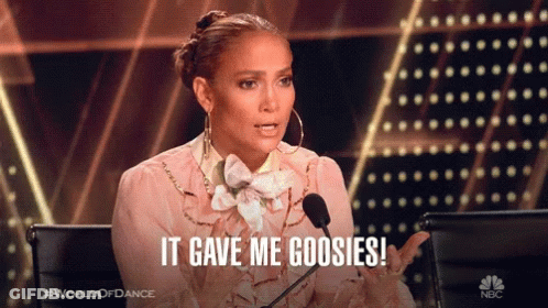 A Woman Sitting In Front Of A Microphone With The Words It Gave Me Goosies GIF