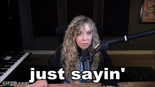 A Woman Sitting In Front Of A Microphone With The Words Just Sayin ' Below Her GIF