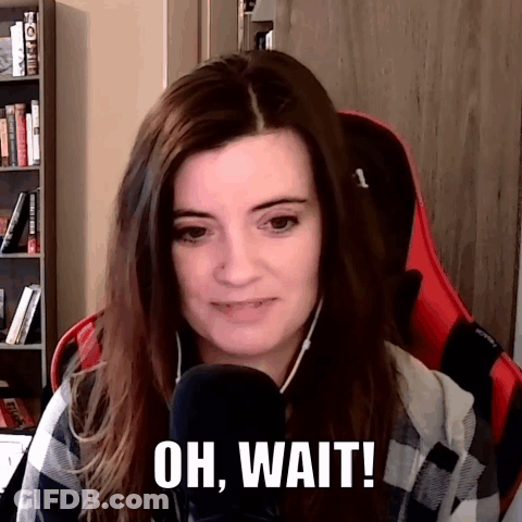 A Woman Sitting In Front Of A Microphone With The Words Oh Wait Written On Her Face GIF