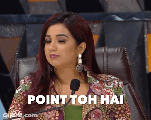 A Woman Sitting In Front Of A Microphone With The Words Point Toh Hai Written On The Screen Behind Her GIF