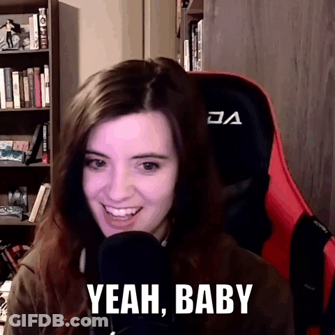 A Woman Sitting In Front Of A Microphone With The Words Yeah Baby On Her Face GIF