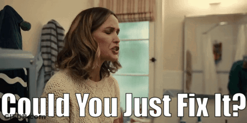 A Woman Sitting In Front Of A Mirror With The Words " Could You Just Fix It " Above Her GIF