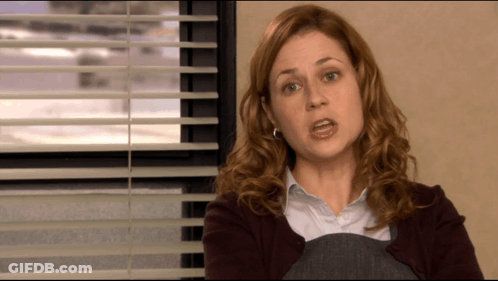 A Woman Sitting In Front Of A Window With Blinds On GIF