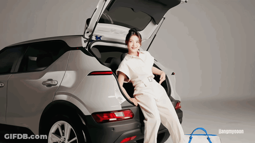 A Woman Sitting In The Back Of A Car With The Word Hangmyeon Behind Her GIF