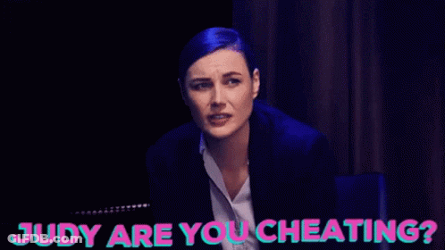 A Woman Sitting Next To Another Woman With Judy Are You Cheating Written On The Bottom GIF