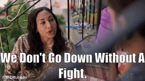 A Woman Sitting On A Balcony With The Words We Don T Go Down Without A Fight Above Her GIF
