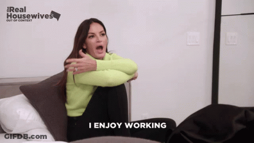 A Woman Sitting On A Bed With A Real Housewives Logo In The Background GIF