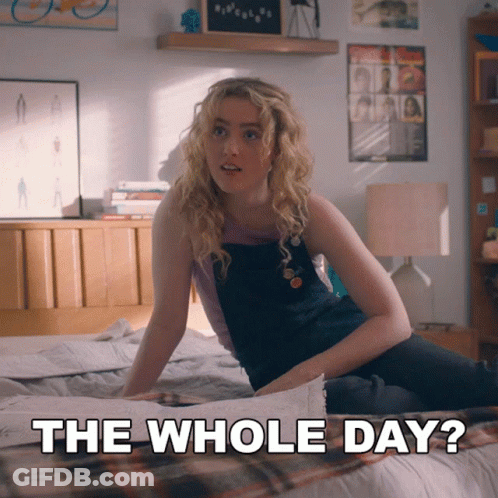 A Woman Sitting On A Bed With The Words " The Whole Day " Next To Her GIF