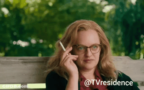 A Woman Sitting On A Bench Smoking A Cigarette With The Words @Tvresidence Written Below Her GIF