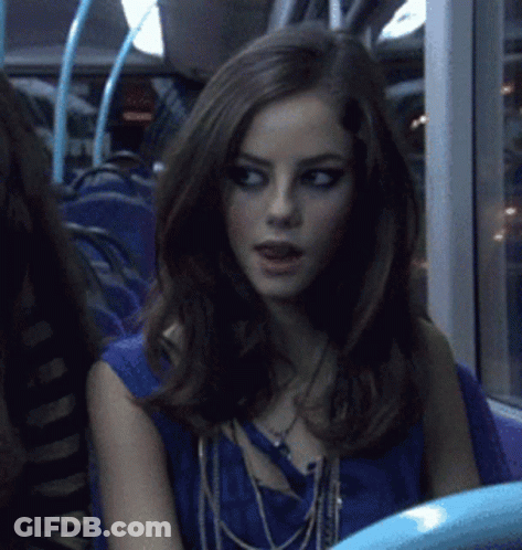 A Woman Sitting On A Bus With A Blue Shirt On GIF