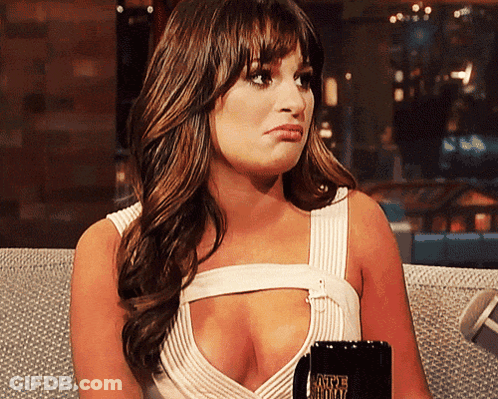 A Woman Sitting On A Couch Holding A Coffee Mug That Says Caffeine Free GIF