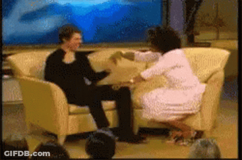 A Woman Sitting On A Couch Talking To A Man GIF