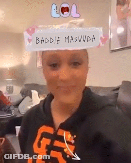 A Woman Sitting On A Couch With A Lol Sign On Her Head . GIF