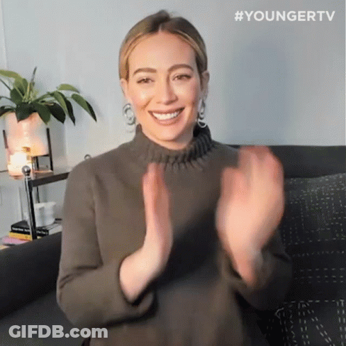 A Woman Sitting On A Couch With Her Hands In The Air And The Hashtag Youngertv GIF