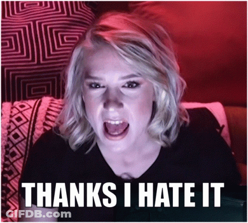 A Woman Sitting On A Couch With Her Mouth Open And The Words Thanks I Hate It GIF