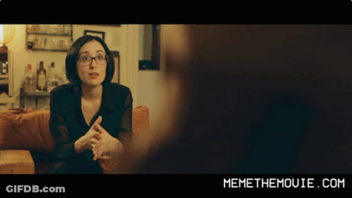 A Woman Sitting On A Couch With Memethemovie.com Written On The Bottom Of The Screen GIF