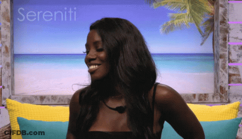 A Woman Sitting On A Couch With Sereniti Written In The Background GIF