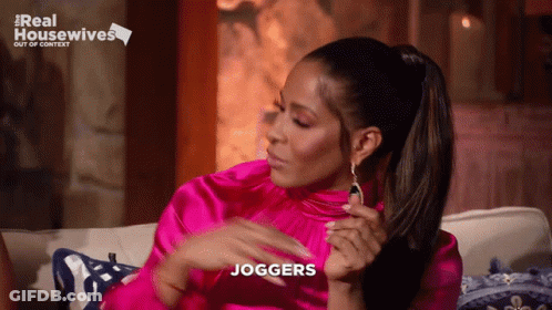 A Woman Sitting On A Couch With The Word Joggers Written On Her Face GIF