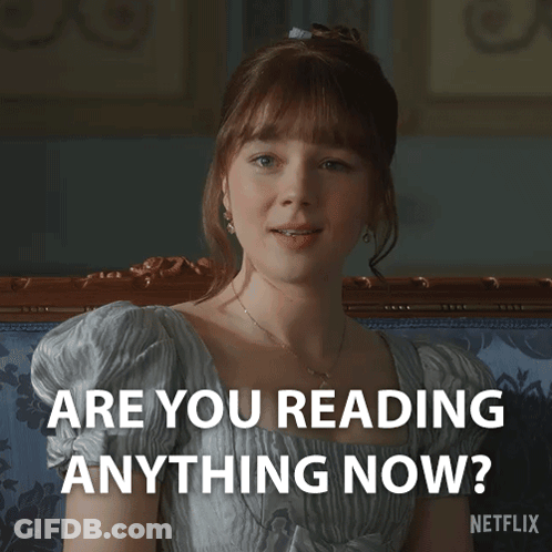 A Woman Sitting On A Couch With The Words " Are You Reading Anything Now " On The Bottom GIF