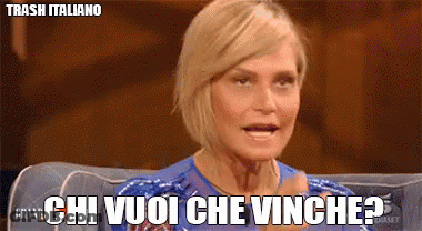 A Woman Sitting On A Couch With The Words Chi Vuoi Che Vinghe Written On Her Face GIF