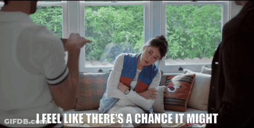 A Woman Sitting On A Couch With The Words " I Feel Like There 'S A Chance It Might " Below Her GIF