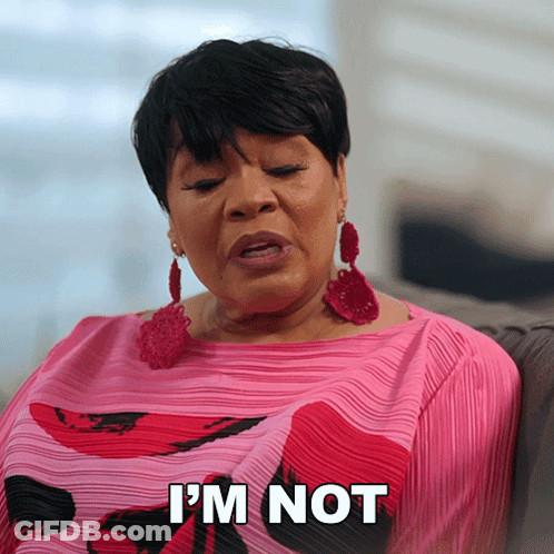 A Woman Sitting On A Couch With The Words I 'M Not On Her Shirt GIF