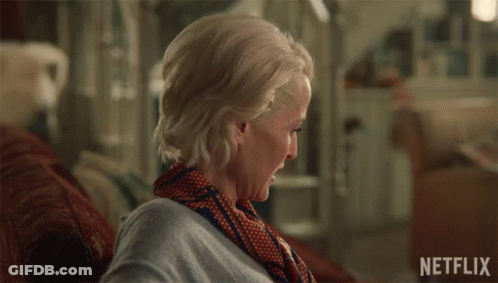 A Woman Sitting On A Couch With The Words I 'M Sorry Written On The Bottom GIF