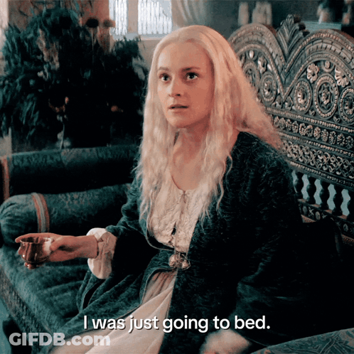 A Woman Sitting On A Couch With The Words I Was Just Going To Bed GIF