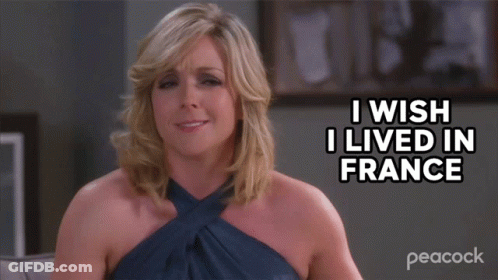 A Woman Sitting On A Couch With The Words I Wish I Lived In France Above Her GIF