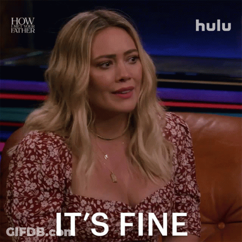 A Woman Sitting On A Couch With The Words " It 'S Fine " On Her Face GIF