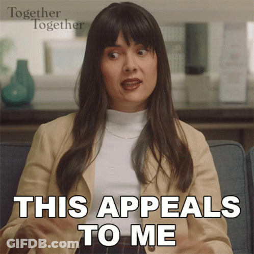 Woman Sitting On Couch Saying This Appeals To Me GIF