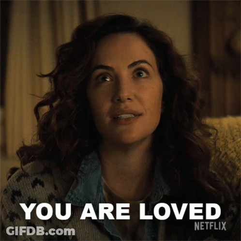 A Woman Sitting On A Couch With The Words " You Are Loved " Written On It GIF