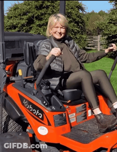 A Woman Sitting On A Kubota Lawn Mower GIF
