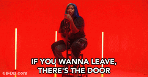 Woman Sitting On Stool Saying If You Wanna Leave There's The Door GIF