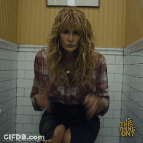 A Woman Sitting On A Toilet With The Words " Is This Thing On " Written On The Bottom GIF