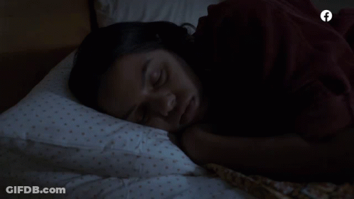 A Woman Sleeping In A Bed With A Facebook Logo On The Bottom GIF