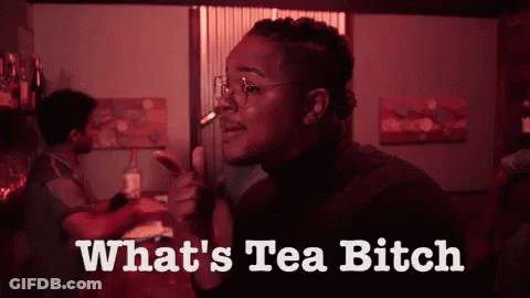 A Woman Smoking A Cigarette With The Words " What 'S Tea Bitch " Below Her GIF